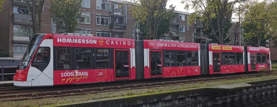 Tramreclame boven en onder de ramen op een Avenio-tram in Den Haag