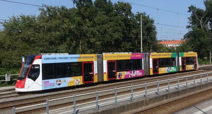 Voorbeeld van een tram in Den Haag met reclame boven en onder de ramen